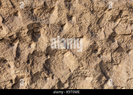 Close up view at brown clay earthen wall texture background Stock Photo