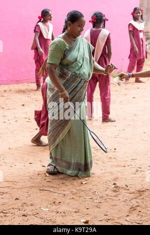 PONDICHERY, PUDUCHERY, INDIA - SEPTEMBER 04, 2017. Active indian preschool girl and boy and teachers playing badminton in outdoor court in summer. Sch Stock Photo