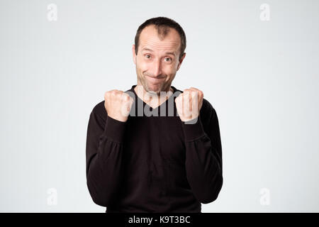 Caucasiasn happy man holding hands like he is saying Yes Stock Photo
