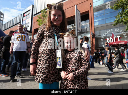 Miami Dolphins fans pose with a jack-o- lantern before an NFL