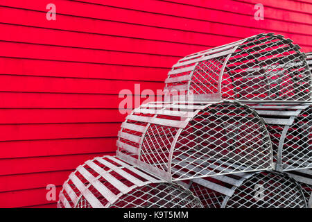 An Display Of Decorative Lobster Traps Sit Against A Red Wall Of A