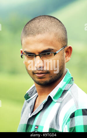 Handsome young man in power glasses on posing outdoor Stock Photo