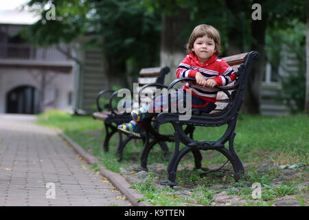 boy kid bench parl alone Stock Photo