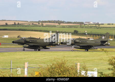 N166EM and N167EM, two Douglas A-4N Skyhawks operated by Draken International's Aggressor Squadron, at Glasgow Prestwick Airport in Ayrshire. Stock Photo