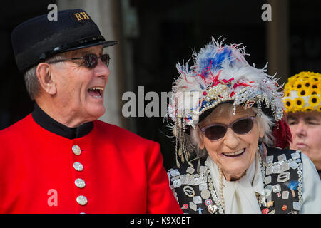 London, UK. 24th September, 2017. Sharing a joke with Chelsea Pensioners - The annual Harvest Festival organised by the Pearly Society starts with a ceremony in Guild hall courtyard and then processes to Bow Church in the City of London. Pearly Kings and Queens of London get together for the biggest event in the Pearly calendar. London 24 Sep 2017. Credit: Guy Bell/Alamy Live News Stock Photo