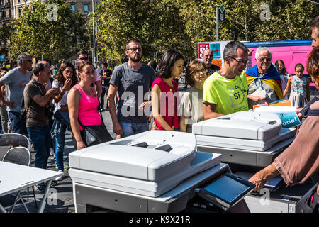 Participants of the marathon for democracy queue up to collect posters.                         Pro independence sovereigntists have called a marathon for democracy, where ballots are being handed out to vote in the referendum on 1st October. Pro independence posters have also been handed out. On September 24, 2017 in Barcelona, Spain. Stock Photo