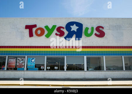 A logo sign outside of a Toys 
