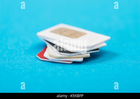 Stack Of Phone Sim Card Over Blue Background Stock Photo