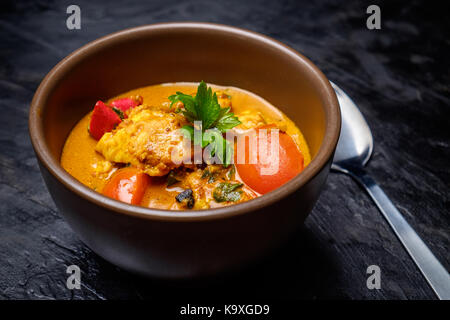 Fish curry in ceramic bowl Stock Photo