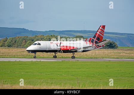 Loganair G-LGNN taxining prior to take off from Inverness Dalcross Airport. in the Scottish Highlands.