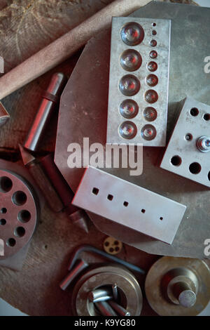 Background image of several metal forms  and casts on table in metalworking shop at jewelry factory Stock Photo