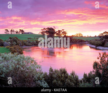 New Zealand. Auckland Region, Rural property with water at sunrise. Stock Photo