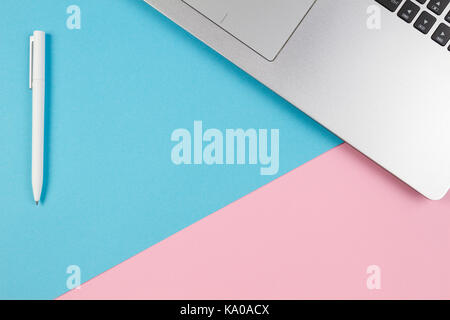 Top view of laptop notebook on blue and pink color background Stock Photo
