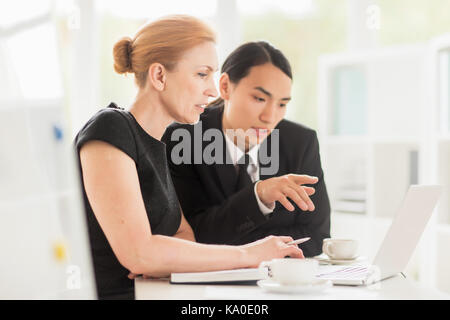 Multi-Ethnic Team Wrapped up in Work Stock Photo