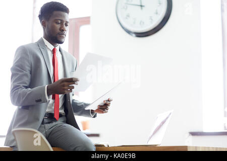 Businessman Wrapped up in Paperwork Stock Photo