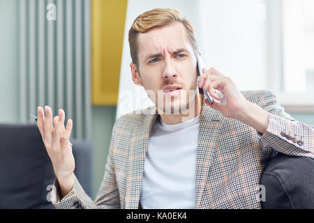 Having Tense Telephone Conversation Stock Photo