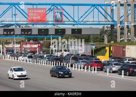 LE HAVRE, FRANCE - AUGUST 24, 2017: Toll station with passing cars for bridge Pont de Normandie over river Seine Stock Photo