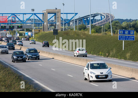 LE HAVRE, FRANCE - AUGUST 24, 2017: Toll station with passing cars at bridge Pont de Normandie over river Seine Stock Photo