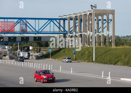 LE HAVRE, FRANCE - AUGUST 24, 2017: Toll station with passing cars at bridge Pont de Normandie over river Seine Stock Photo