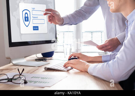 Cyber security concept with manager providing authentication credentials (login, password) to business person to access confidential data on computer  Stock Photo