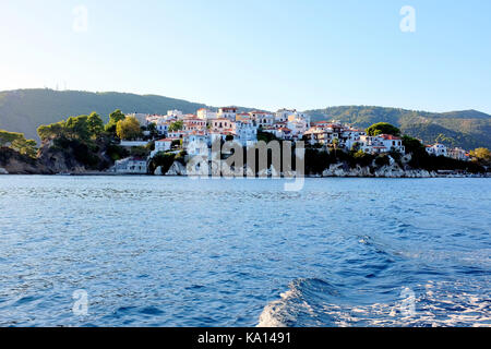 Skiathos, Greece. September 13, 2017.  Taken from a water taxi of the evening sunlight falling on the Plakes part of Skiathos town on the Island. Stock Photo