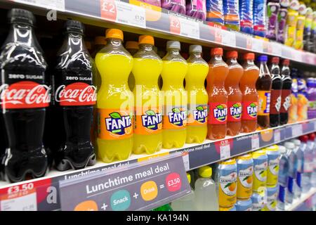 Fizzy drinks on display on a supermarket shelf. Stock Photo