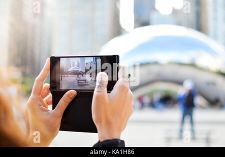 Tourist taking picture of a landmark in Chicago, Illinois, enjoying a sunny day Stock Photo