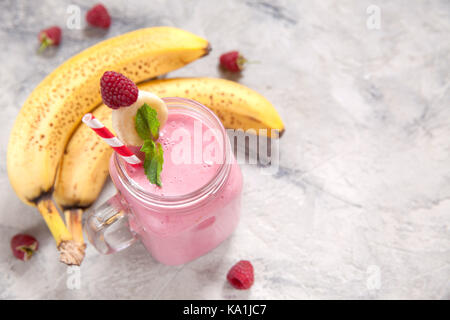 Banana raspberry smoothie in a mason jar