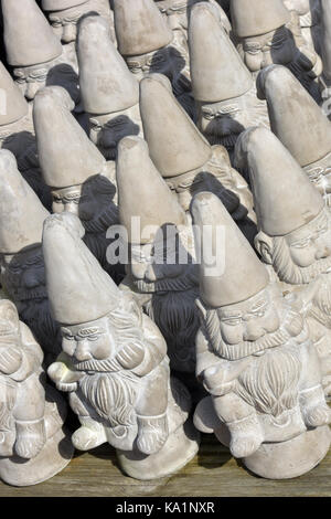 Rows or lines of garden gnomes made from stone or concrete for sale at a garden centre. Stock Photo
