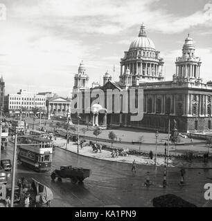 Early 1950s, historical picture by J Allan Cash of the highly ornate Baroque style civic building, City Hall, Belfast completed in 1906. Surrounding it, general activit of the era, showing pedestrians, trams, cars and a delivery truck with barrels. Stock Photo