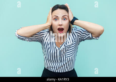 No way! Surprised business business woman with opened mouth and big eyes. Looking at camera. Isolated on blue background, studio shot Stock Photo