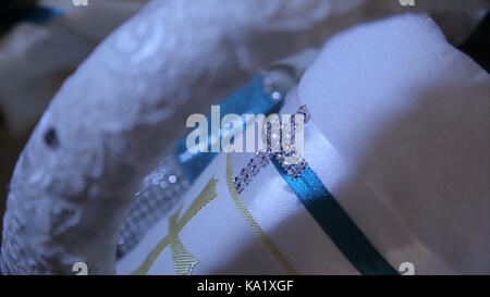 Fabric with a bright cross. ross-stitch, needlework and tailoring concept - thread stitching on white fabric. napkin with the image of God cross. Selective focus. Cross Stock Photo