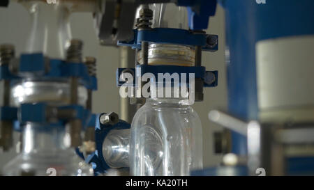 Liquid flows through a transparent pipe. Experience in chemical laboratory Stock Photo