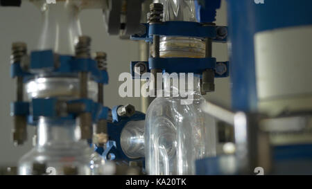 Liquid flows through a transparent pipe. Experience in chemical laboratory Stock Photo