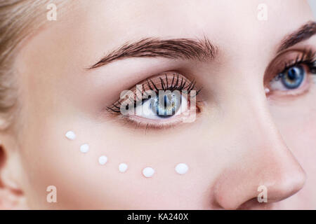 Young woman with cream on clean fresh face. Stock Photo