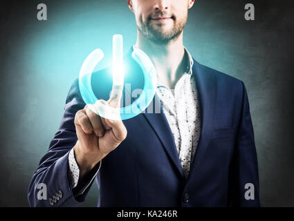 Businessman pressing power futuristic button. Stock Photo
