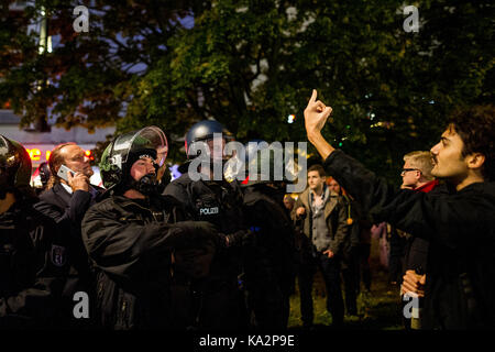 Berlin, Germany. 24th Sep, 2017. Several participants of the election party had to be escorted by policemen to a taxistand when they were surrounded by demonstrators. Several hundred people demonstrate in front of a club in Berlin, where the AfD is organizing its election party. On September 24, 2017 in Berlin, Germany. Credit: SOPA Images Limited/Alamy Live News Stock Photo