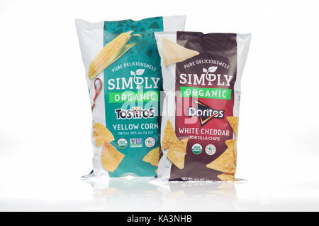 Bags of Simply Organic  white cheddar Doritos and yellow corn Tostitos by Frito-lay on white background. USA Stock Photo