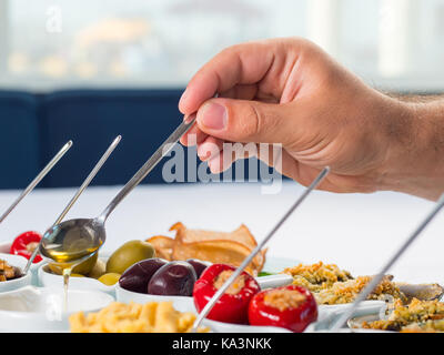 Snack set. Oktoberfest food frame concept. Variety of humus, olives, vegetables, cheese and sauces on white background. Top view Stock Photo