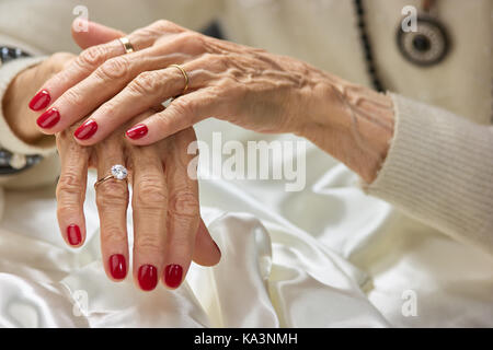 Manicured hands holding ring with diamond Stock Photo - Alamy