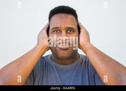 one black man covering ears-hear no evil Stock Photo
