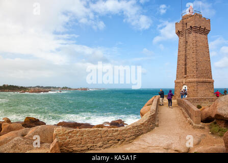 People visiting the lighthouse of Ploumanac'h at the french Côte de granite rose in Brittany Stock Photo