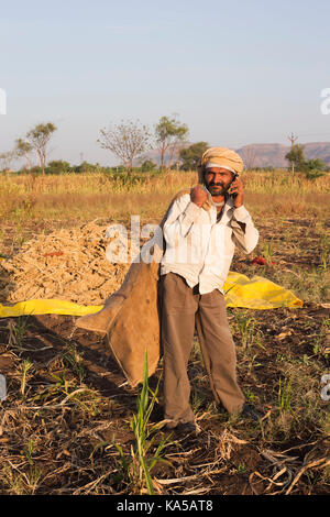 farmer talking on mobile phone, Chinchani, maharashtra, India, Asia MR#793 Stock Photo