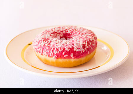 Brightly pink donut on white background Stock Photo
