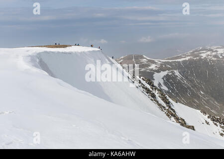 People on Swirral Edge in Late Winter Conditions, Helvellyn Range, Lake District, Cumbria, UK Stock Photo