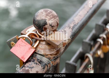 Lock as a symbol of eternal love. Metal locks on the railing of the pier in the Baltic Sea Stock Photo