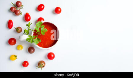 Ketchup and small cherry tomatoes on white background isolated Stock Photo