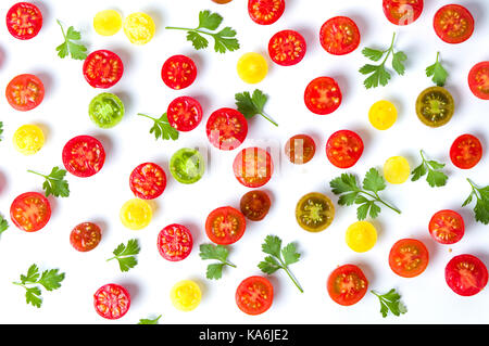 Sliced small cherry tomatoes and parsley background flat lay Stock Photo