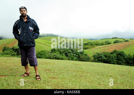 Beautiful young man smiling and posing with mountains landscape Stock Photo