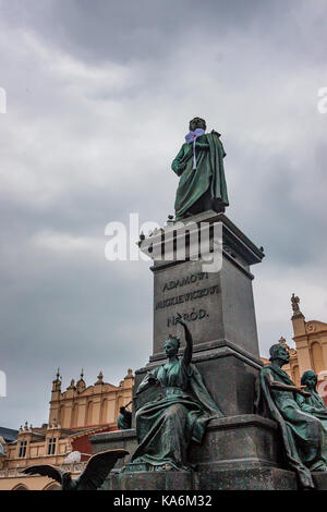 KRAKOW, POLAND - JUNE, 2012: Adam Mickiewicz Monument in square and people resting around it Stock Photo